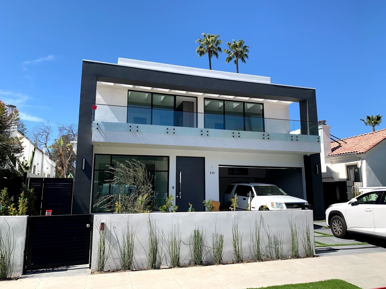 Modern two-story home with contrasting white and dark exterior finishes